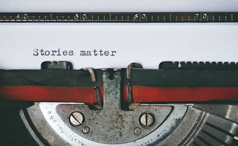 A typewriter with the words "Stories matter" typed on the page