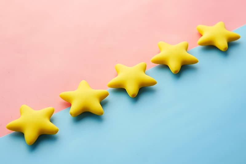 Five stars on a light pink and blue background