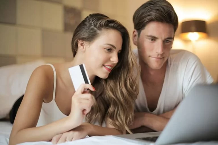 A couple in front of a laptop launching an e-commerce website