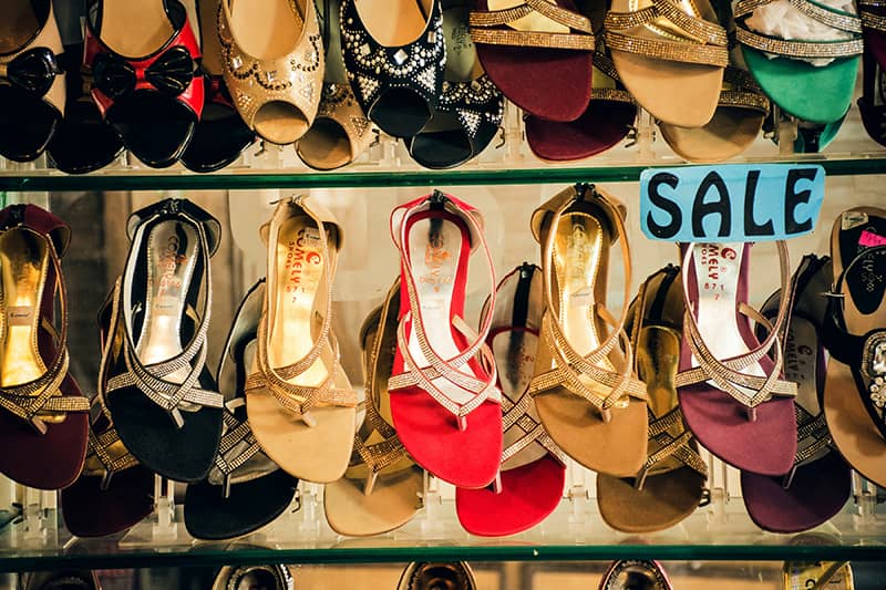 A shoe rack with a sale sign