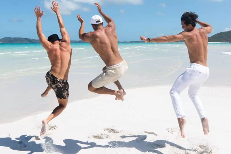 Three guys jumping in the air celebrating a travel website development company