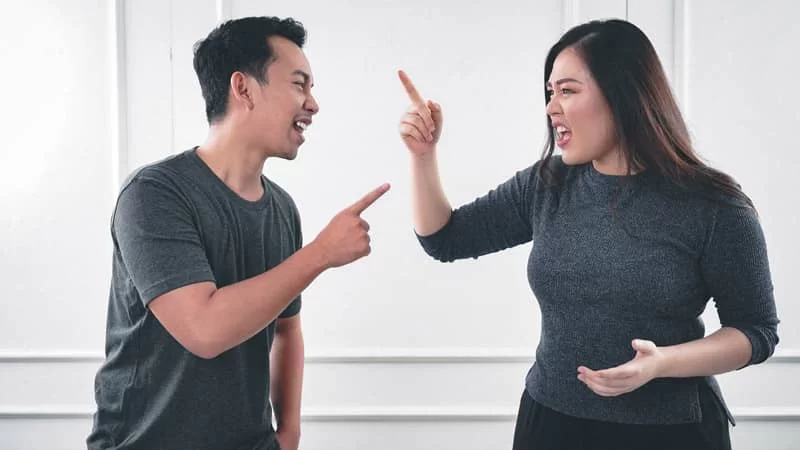 A man and lady yelling and pointing at each other