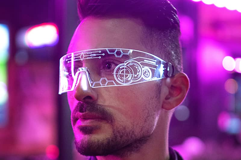 A man wearing future glasses that have a unique white interface