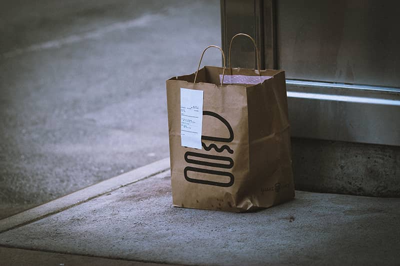 A food delivery bag sitting out the front of a customers door