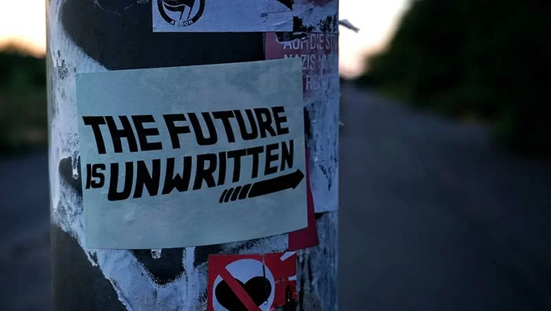 A poster on a wall with the words "The future is unwritten