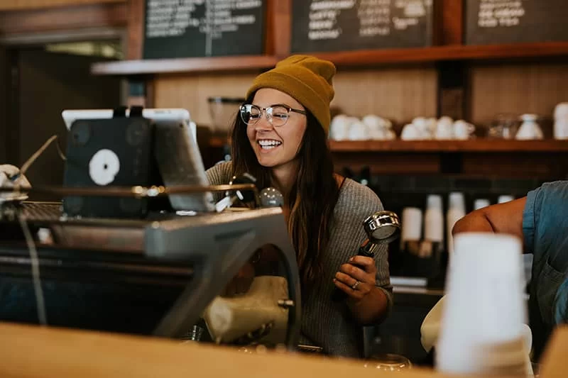A coffee barista making a coffee in a coffee shop