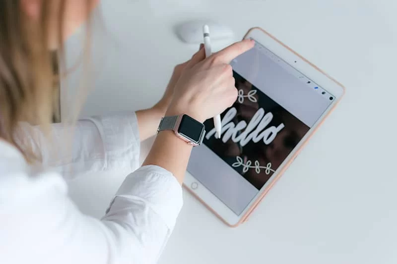 A lady pointing to her design on an iPad.