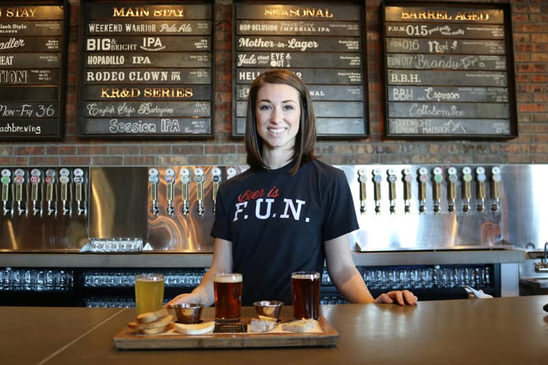 A small business owner serving craft beer